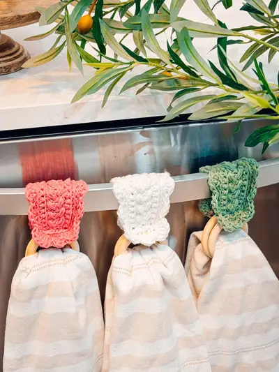 Wheat Stitch Scalloped Dishtowel Holders in coral, cream and sage on an oven handle