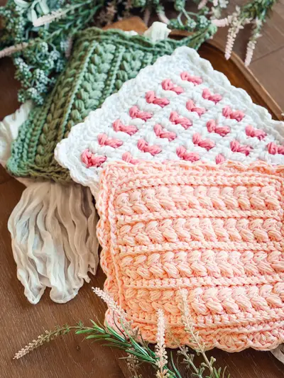 Stack of Wheat Stitch Scalloped Hotpads in sage, white and peach