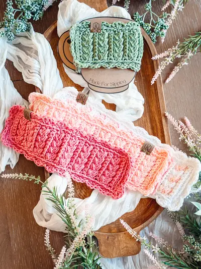 Wheat Stitch Scalloped Mug Cozies in coral, peach and sage laid flat