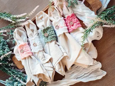 Napkins rolled in Wheat Stitch Scalloped Napkin Rings in pink and sage