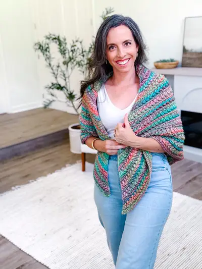 Woman wearing a multicolor striped Wheat Stitch Triangle Shawl