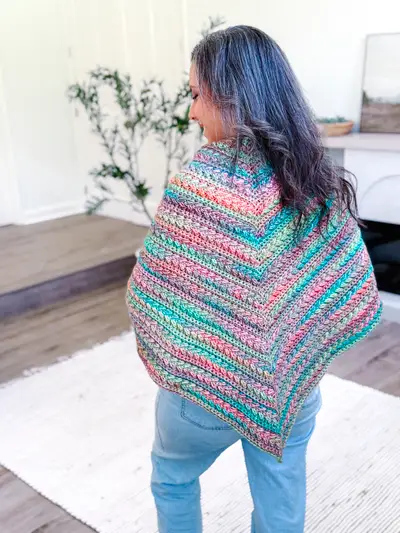 Back view of the striped Wheat Stitch Triangle Shawl worn over the shoulders