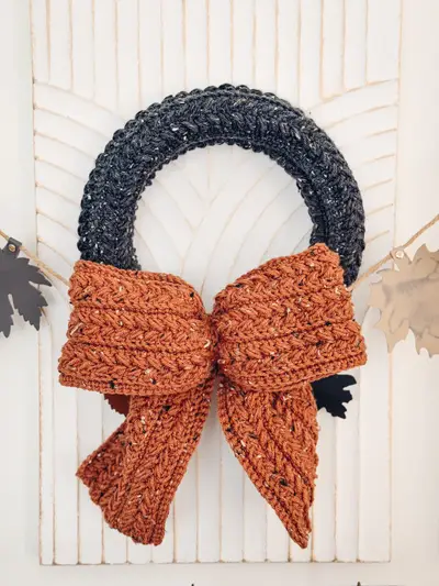 Black Wheat Stitch Wreath with a large rust bow
