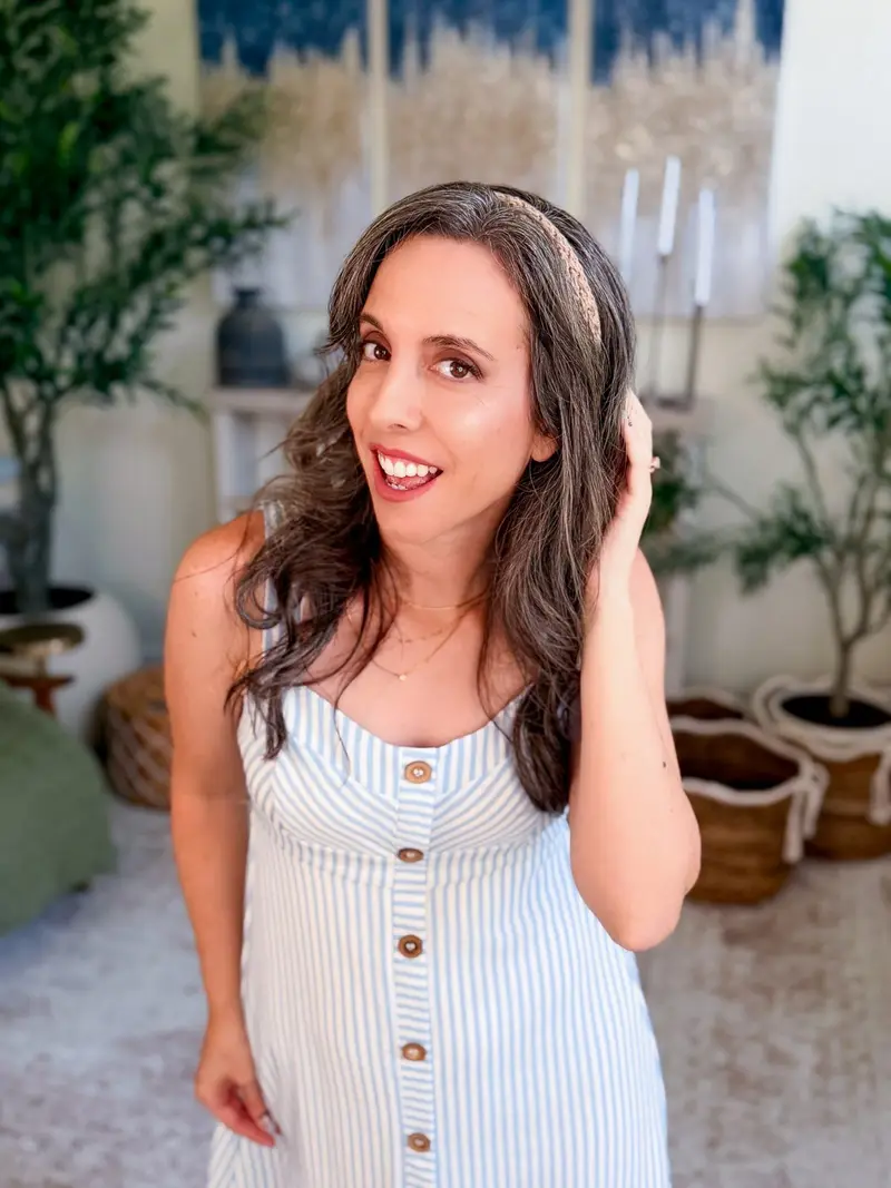 Woman wearing a cream Wheatfield Crochet Headband with a striped sundress