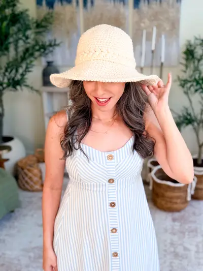 Cream Wheatfield Sun Hat worn with a striped sundress