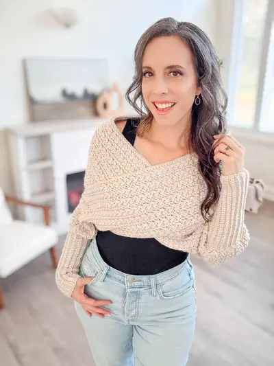 Woman wearing the cream Winter Wheat Sweater Scarf over a black top