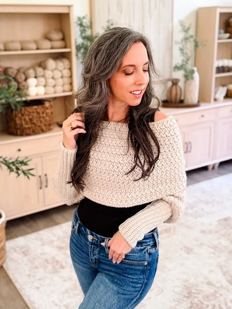 Woman wearing the cream Winter Wheat Sweater Scarf off the shoulder