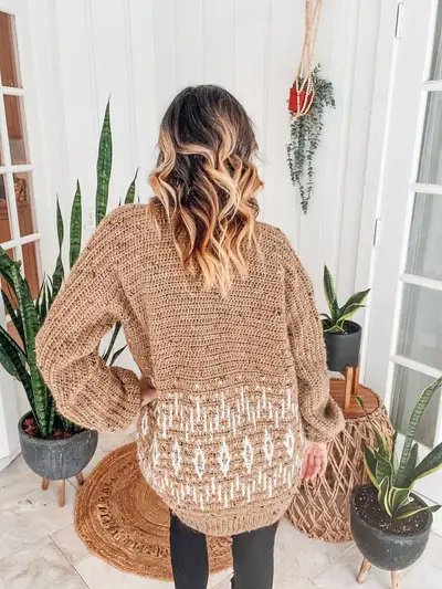 Back view of the tan cardigan showing the cream mosaic star band